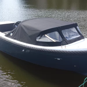 Corsiva 595 Tender mit geschlossener Hafenpersenning im Wasser.