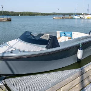 Graue Corsiva 607 Runabout mit offenem Cockpit am Steg eines Yachthafens