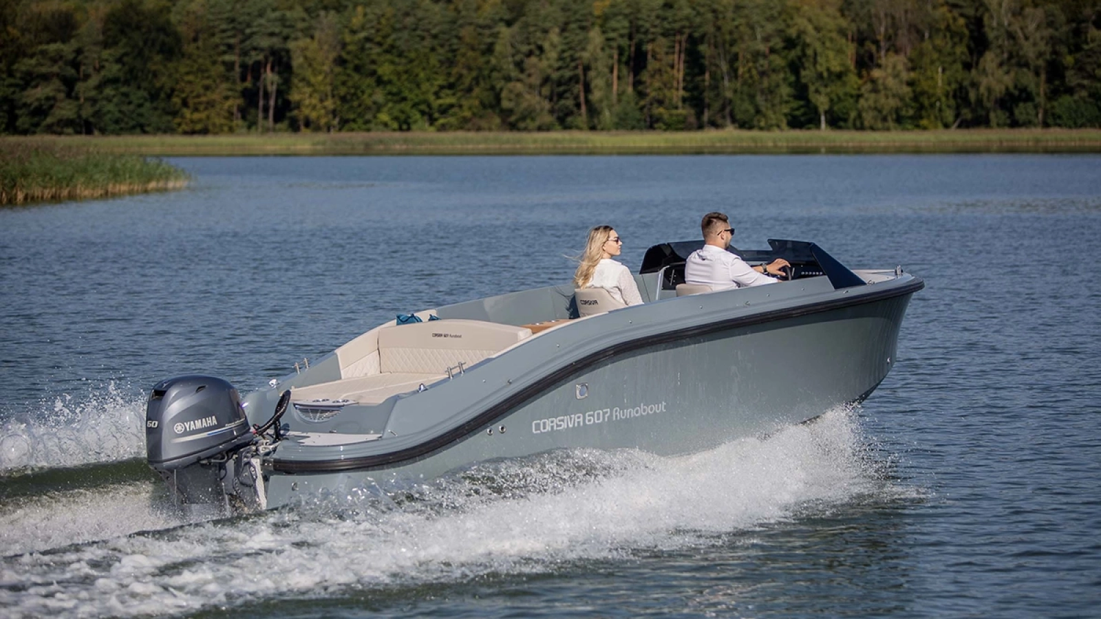Corsiva 607 Runabout mit zwei Personen auf einem See – modernes Motorboot mit Außenbordmotor, großzügigem Cockpit und sportlichem Design.